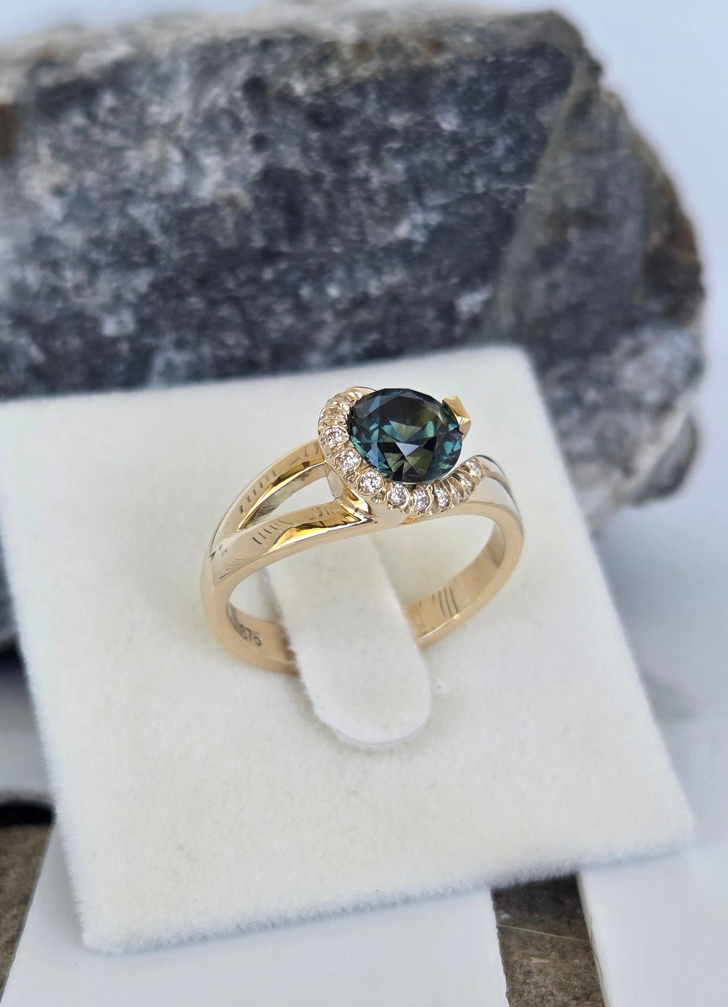 Blue Parti Sapphire custom made ring with diamond set spiral curl surround     Design Ref: #01557