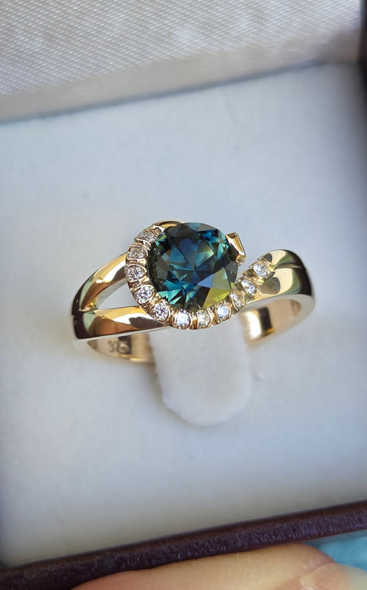 Blue Parti Sapphire custom made ring with diamond set spiral curl surround     Design Ref: #01557