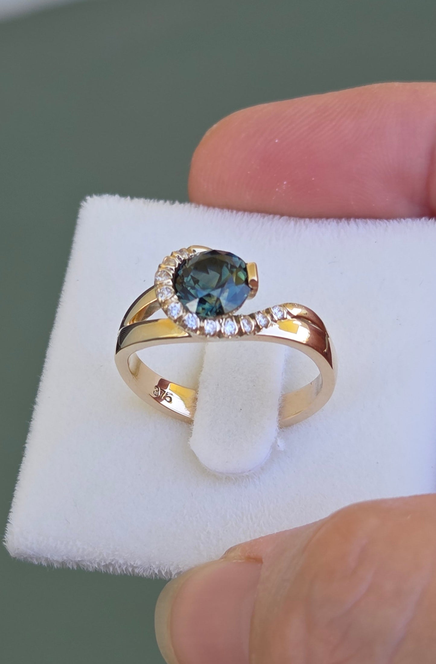 Blue Parti Sapphire custom made ring with diamond set spiral curl surround     Design Ref: #01557