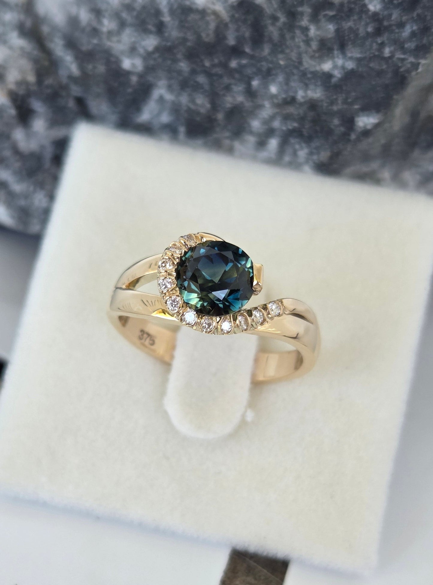Blue Parti Sapphire custom made ring with diamond set spiral curl surround     Design Ref: #01557