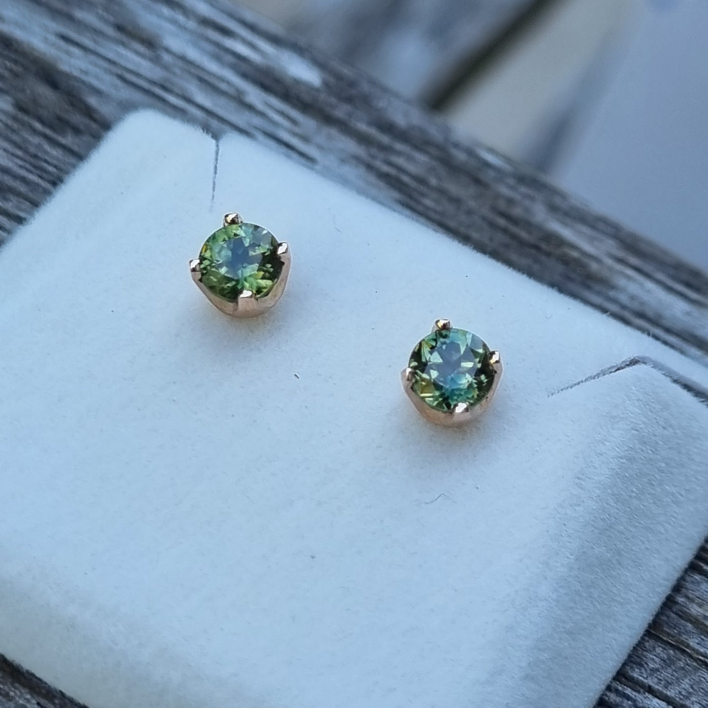 Classic 4 claw style earring studs set with Green Parti-coloured Sapphires in 9ct Yellow Gold